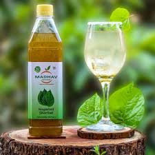 Refreshing Nagarvel Paan Sharbat bottle by Madhav Farm Fresh served in a glass